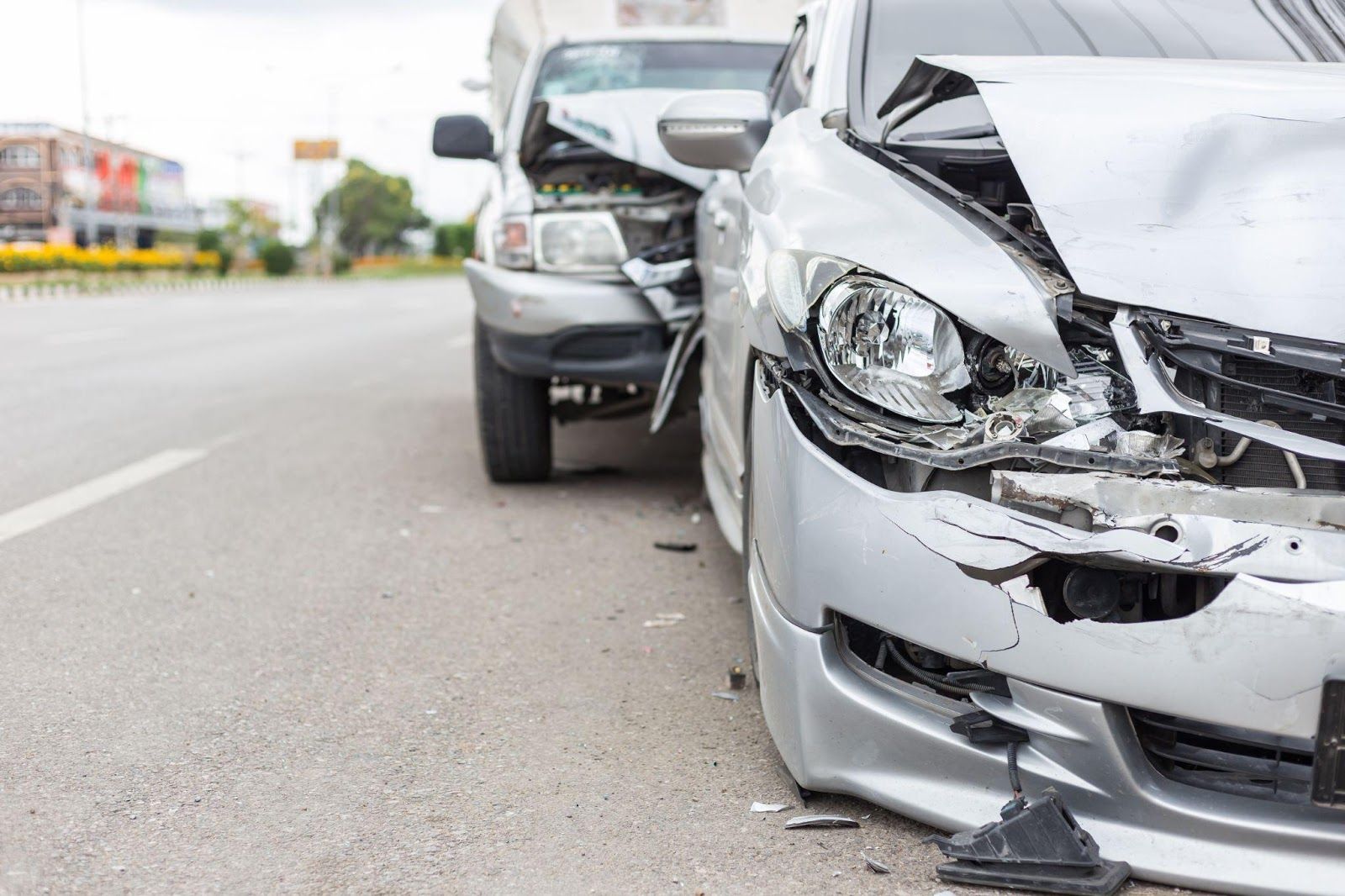 two cars on the road that have been in an auto accident