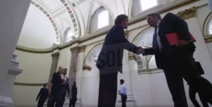 A lawyer and client shaking hands outside of the courtroom